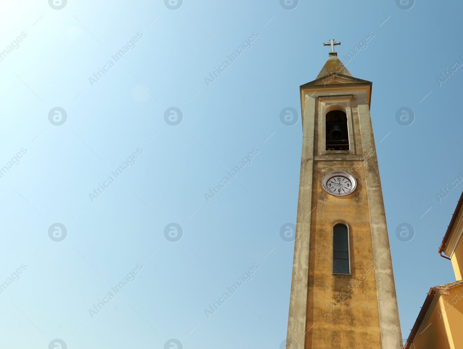 Photo of Beautiful church steeple with clock on sunny day, space for text
