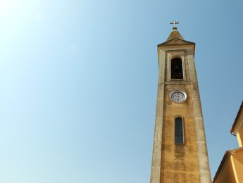 Beautiful church steeple with clock on sunny day, space for text