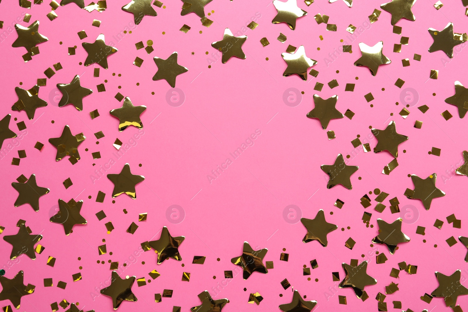 Photo of Frame of shiny golden confetti on pink background, flat lay. Space for text