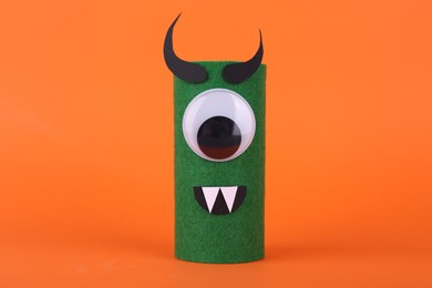 Photo of Spooky monster on orange background. Handmade Halloween decoration