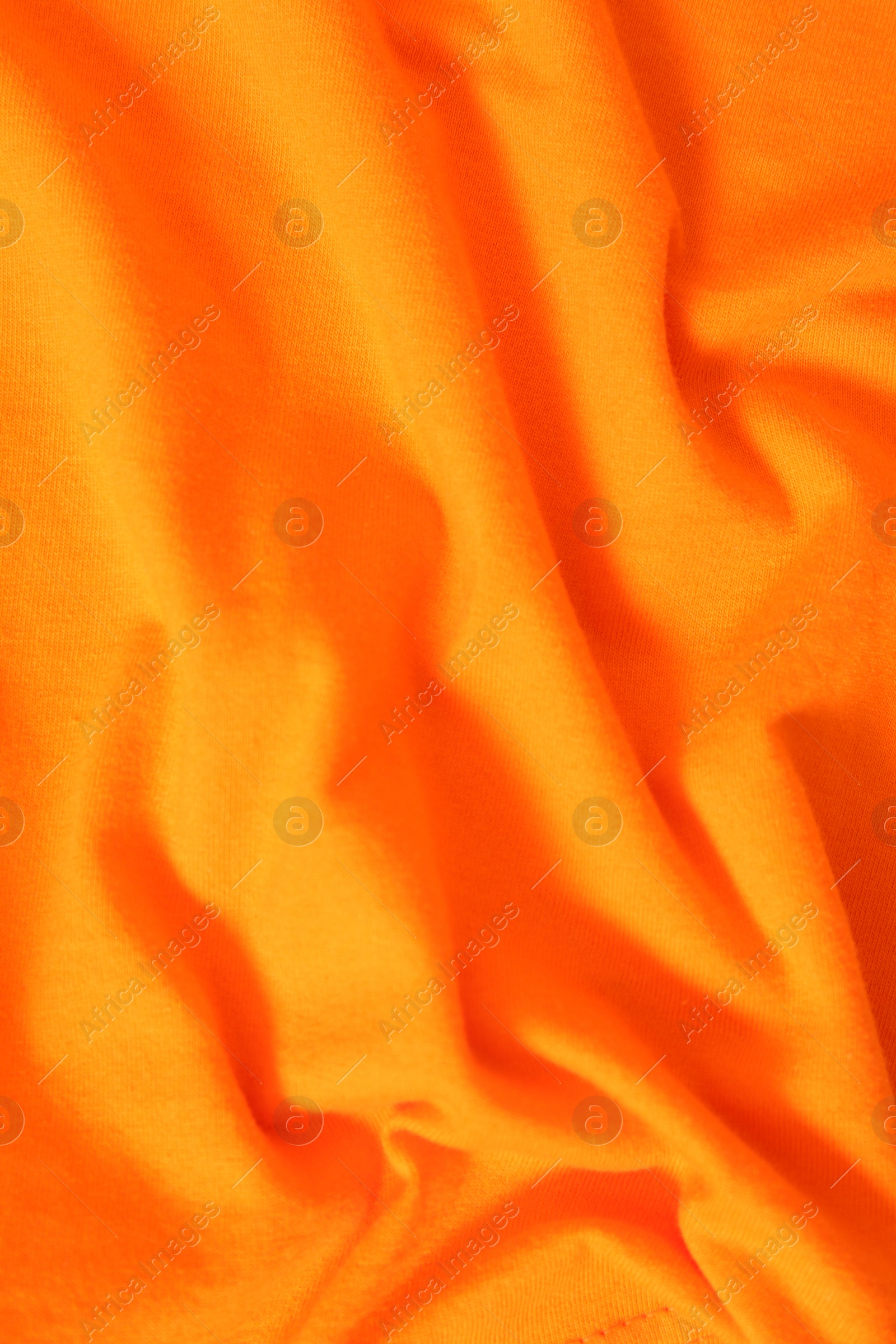 Photo of Texture of orange fabric as background, top view
