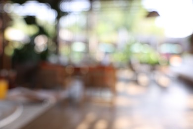 Photo of Blurred view of comfortable cafeteria with furniture