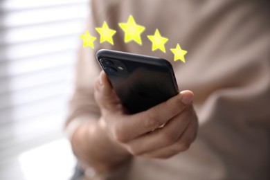 Image of Man with smartphone giving feedback indoors, closeup. Customer review
