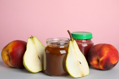 Photo of Healthy baby food and ingredients on grey table against pink background