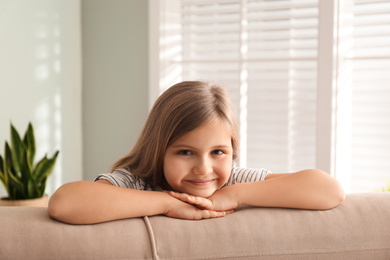 Photo of Cute little girl on couch at home