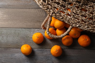 Photo of Many fresh ripe tangerines on wooden table, flat lay