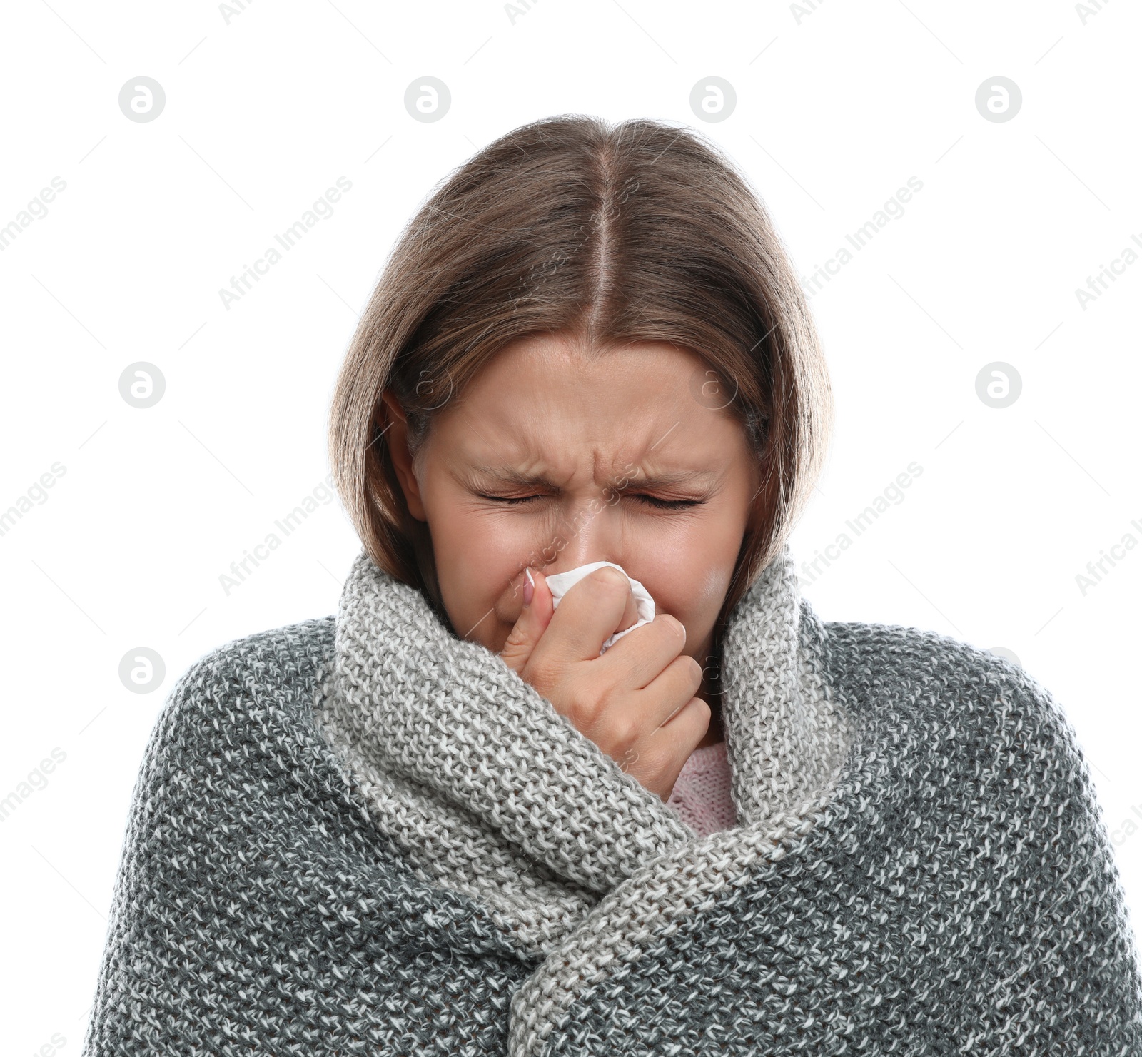 Photo of Young woman wrapped in warm blanket suffering from cold on white background