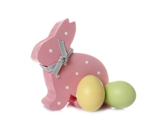 Cute wooden Easter bunny and dyed eggs on white background