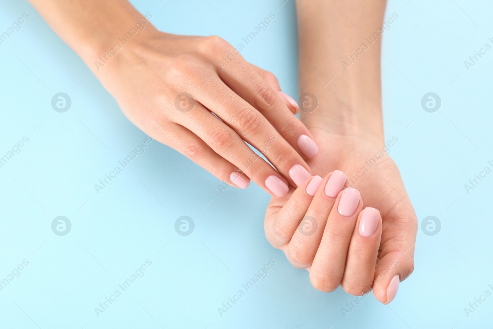 Photo of Closeup view of woman with beautiful hands on color background, space for text. Spa treatment