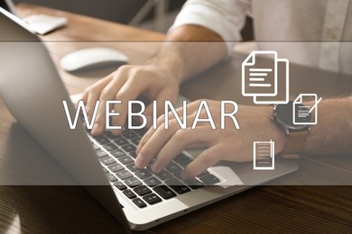 Webinar concept. Man working with laptop at table indoors, closeup