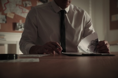 Detective working at desk in his office, closeup