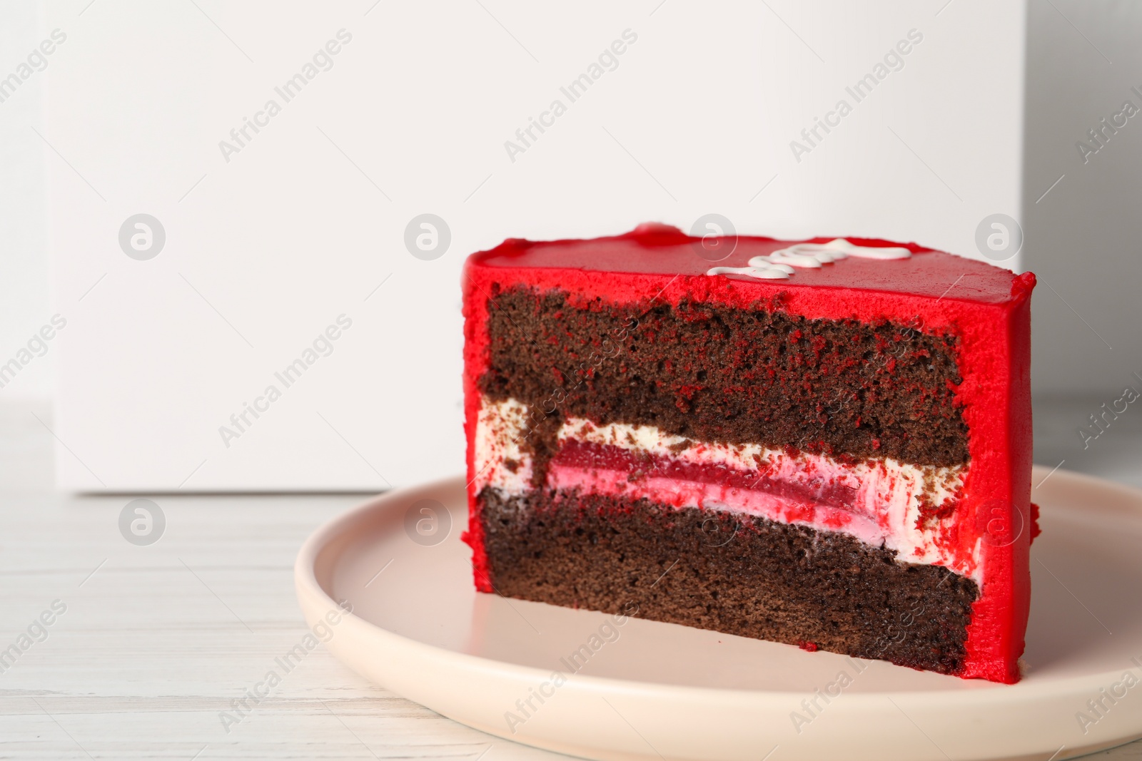 Photo of Cut bento cake on white table, closeup. Space for text