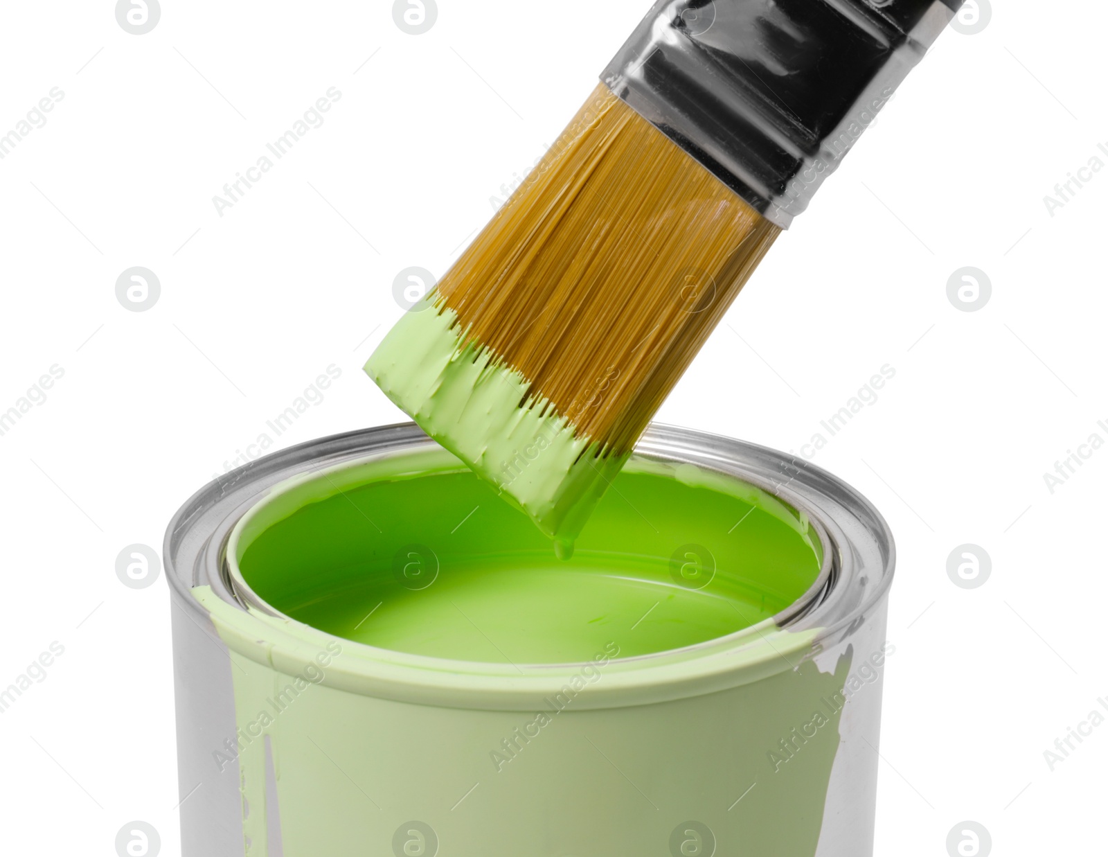 Photo of Can with light green paint and brush on white background, closeup