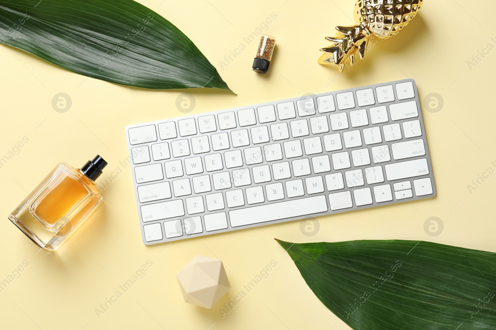 Photo of Creative flat lay composition with tropical leaves and computer keyboard on color background