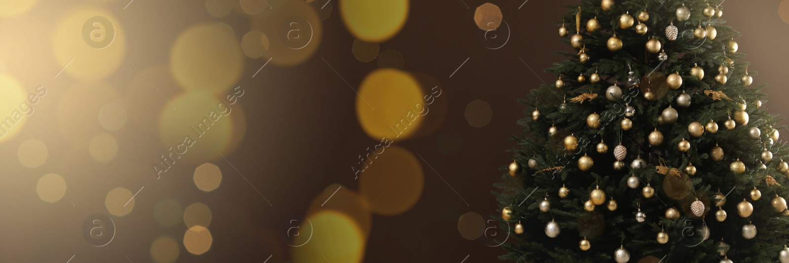 Image of Beautifully decorated Christmas tree on brown background, space for text. Banner design