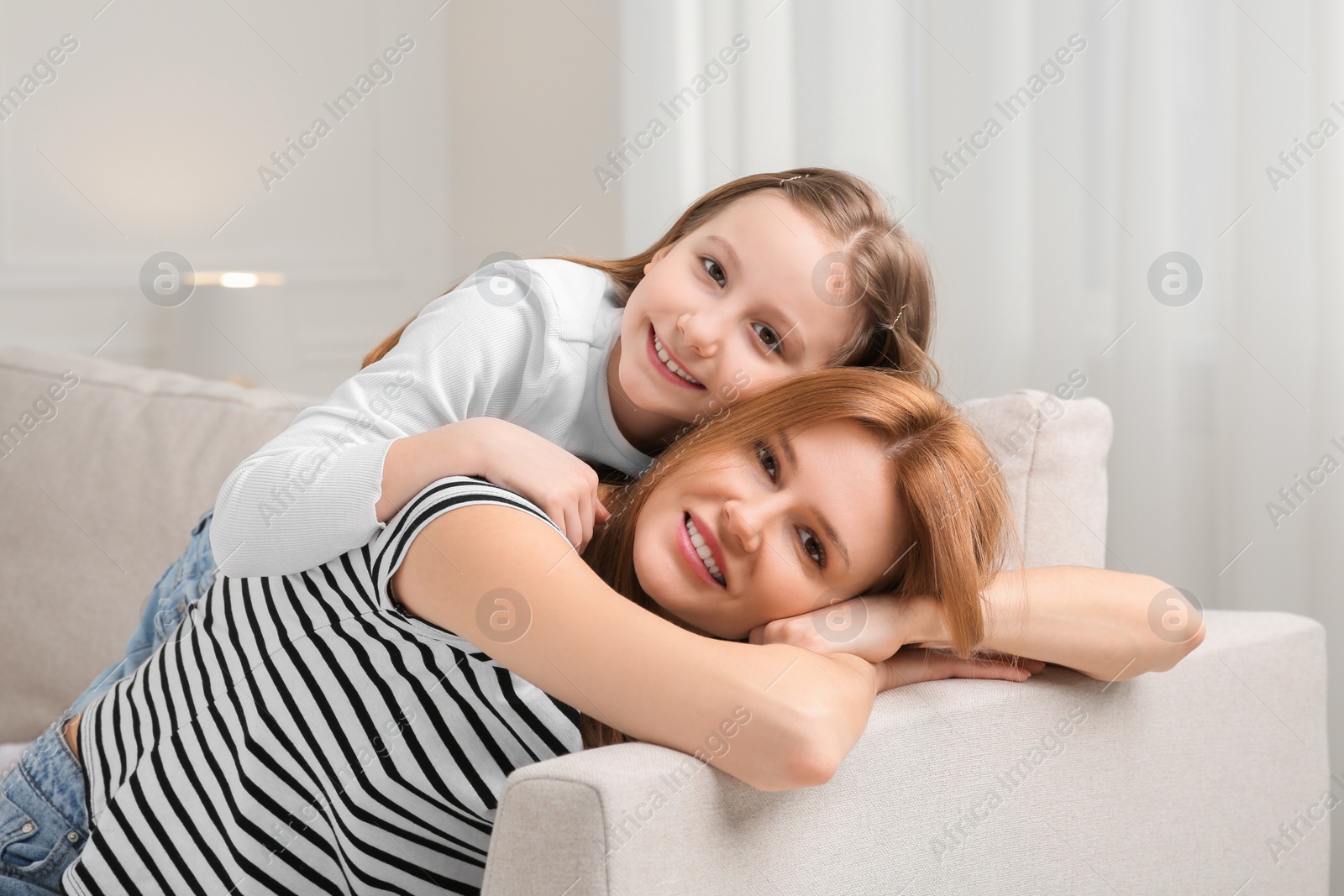 Photo of Mother and her cute daughter spending time together at home