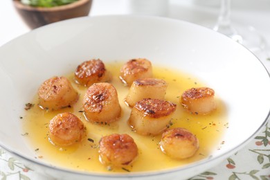 Photo of Delicious fried scallops with sauce on table, closeup
