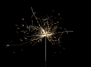 Image of Beautiful sparkler burning on black background. Party decor