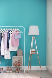 Photo of Stylish dressing room interior with clothes rack