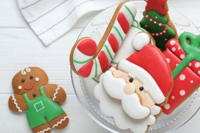 Decorated Christmas cookies on white wooden table, flat lay