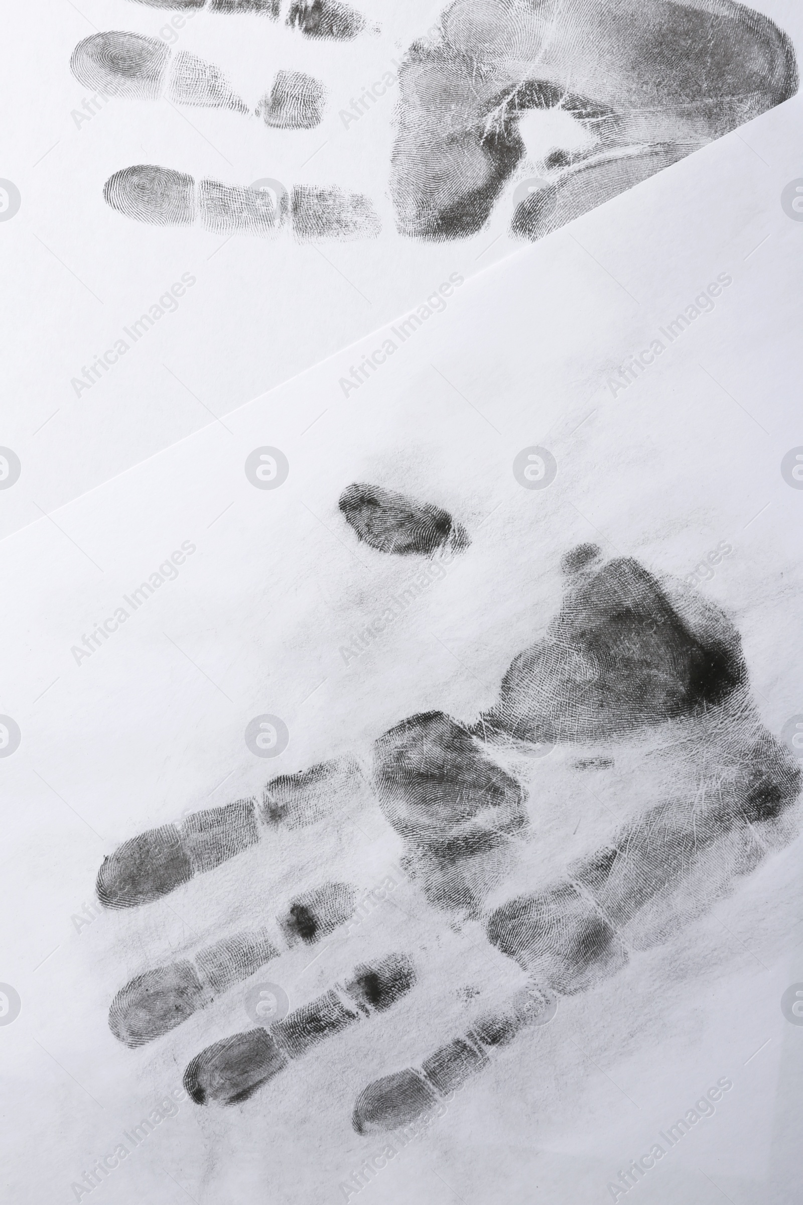 Photo of Print of hands and fingers on white background, top view. Criminal investigation