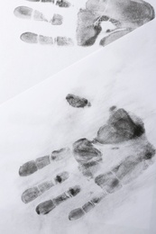 Print of hands and fingers on white background, top view. Criminal investigation