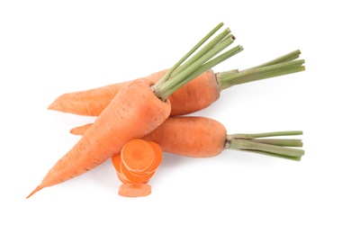 Whole and cut ripe carrots isolated on white, top view