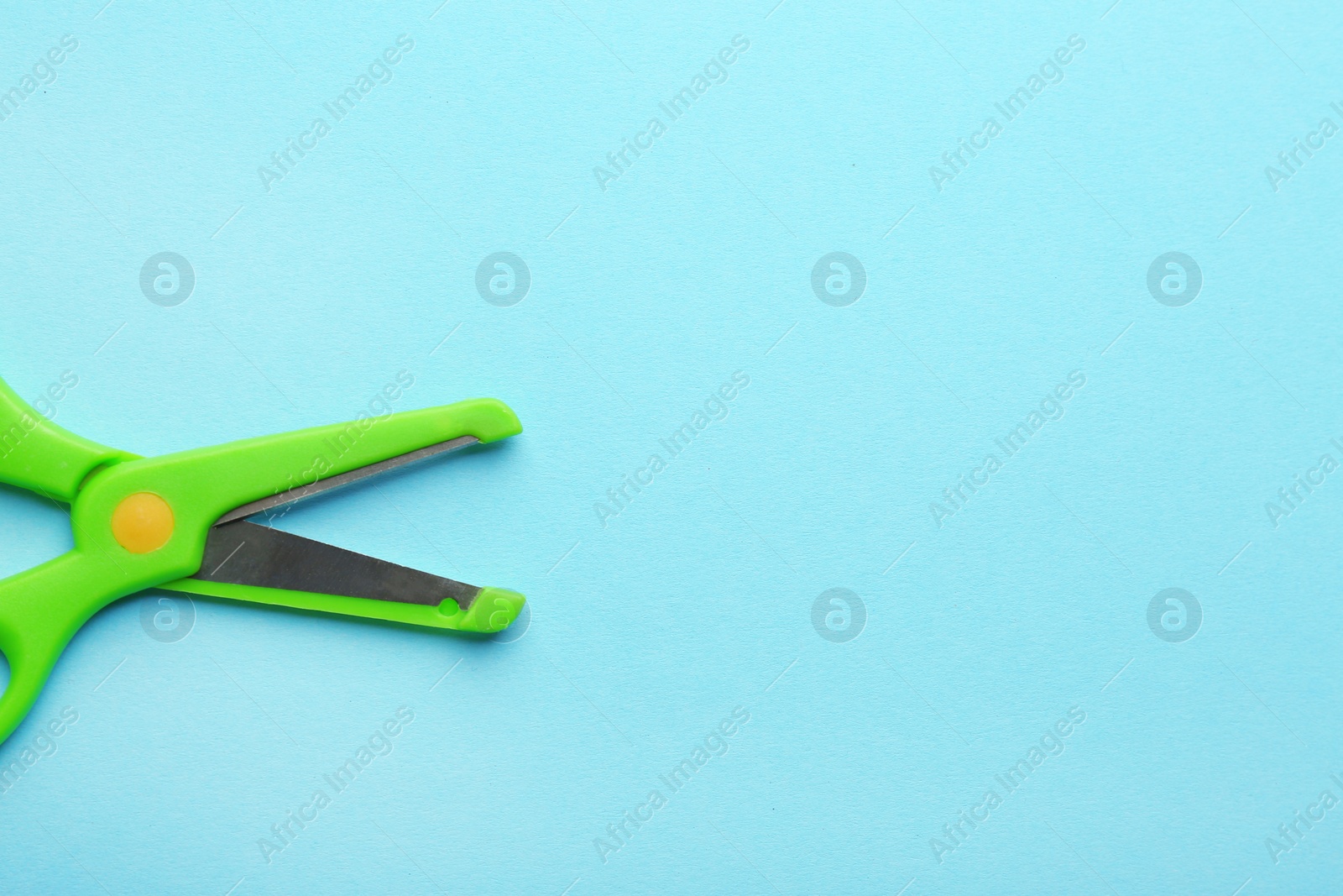 Photo of Training scissors on color background, top view. Space for text
