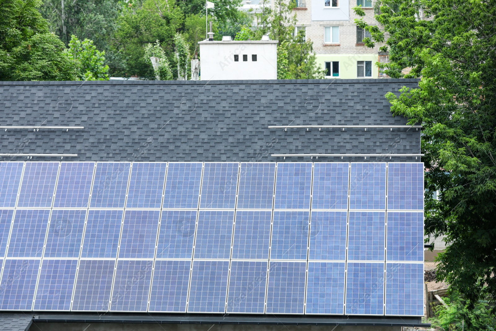 Photo of Building with installed solar panels on roof. Alternative energy source