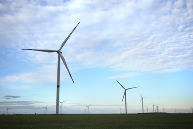 Photo of Beautiful view of field with wind turbines. Alternative energy source