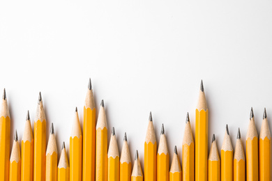 Photo of Graphite pencils on white background, top view. Space for text