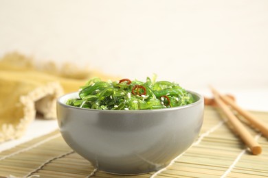 Japanese seaweed salad served on table, closeup