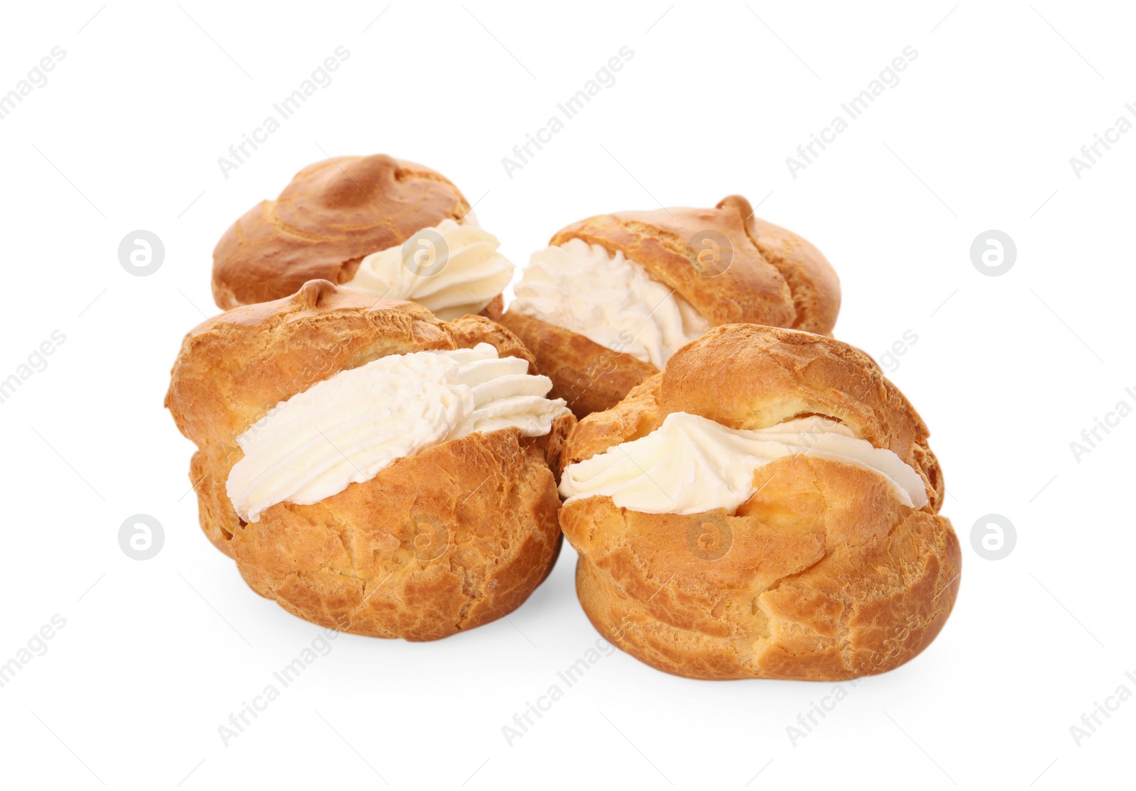 Photo of Delicious profiteroles with cream filling on white background