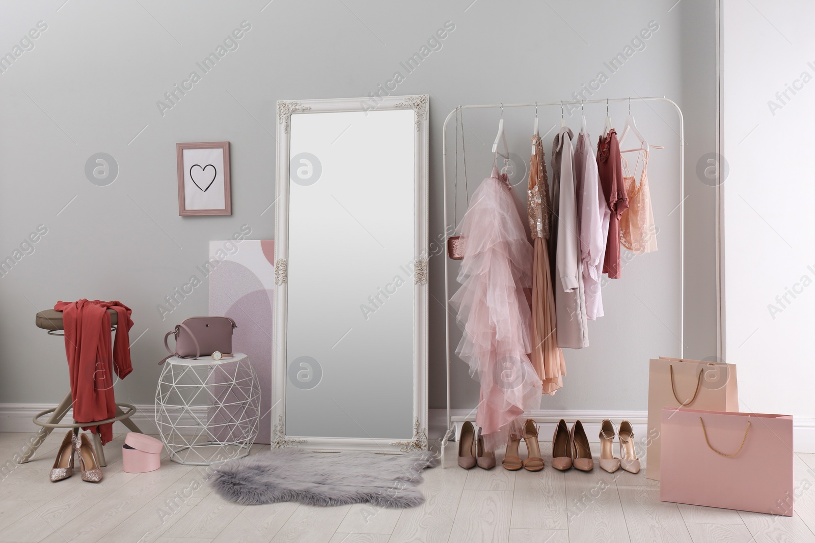 Photo of Modern dressing room interior with clothing rack and mirror