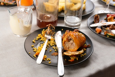 Food leftovers after party on table with cloth