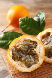 Delicious ripe granadillas on wooden table, closeup