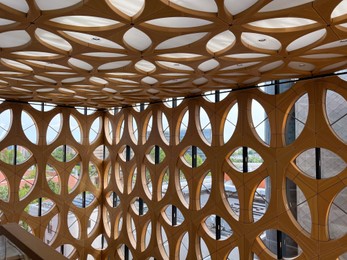 Photo of Decorative wooden pattern covering wall and ceiling in building