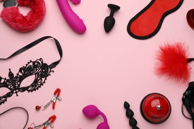 Photo of Frame of sex toys and accessories on pink background, flat lay. Space for text