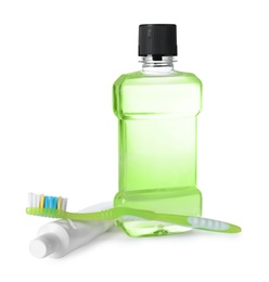 Photo of Mouthwash and other items for teeth care on white background