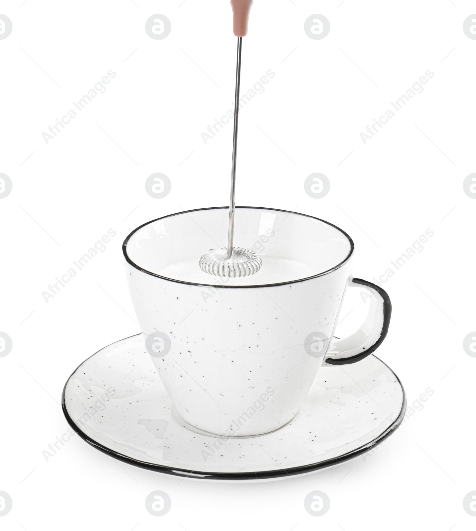 Photo of Whisking milk in cup with mini mixer (frother wand) isolated on white