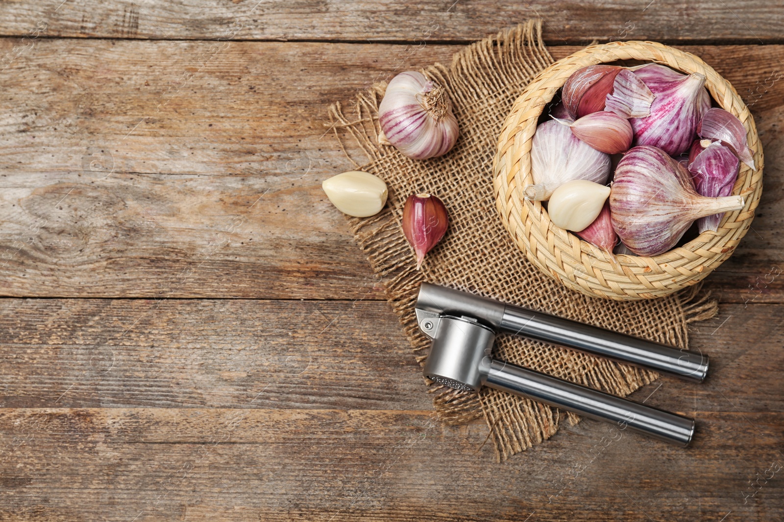 Photo of Flat lay composition with garlic press on wooden table