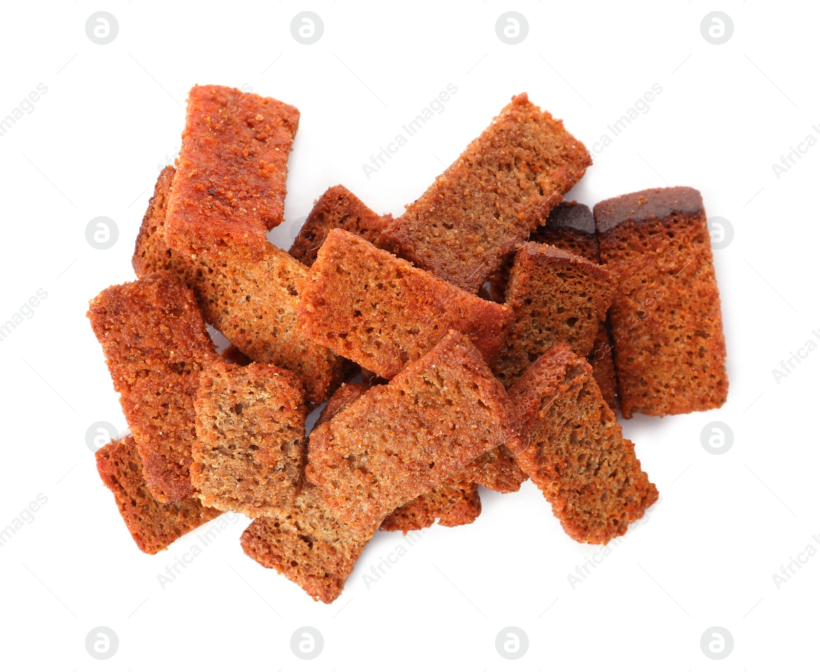 Photo of Heap of crispy rusks with seasoning on white background, top view