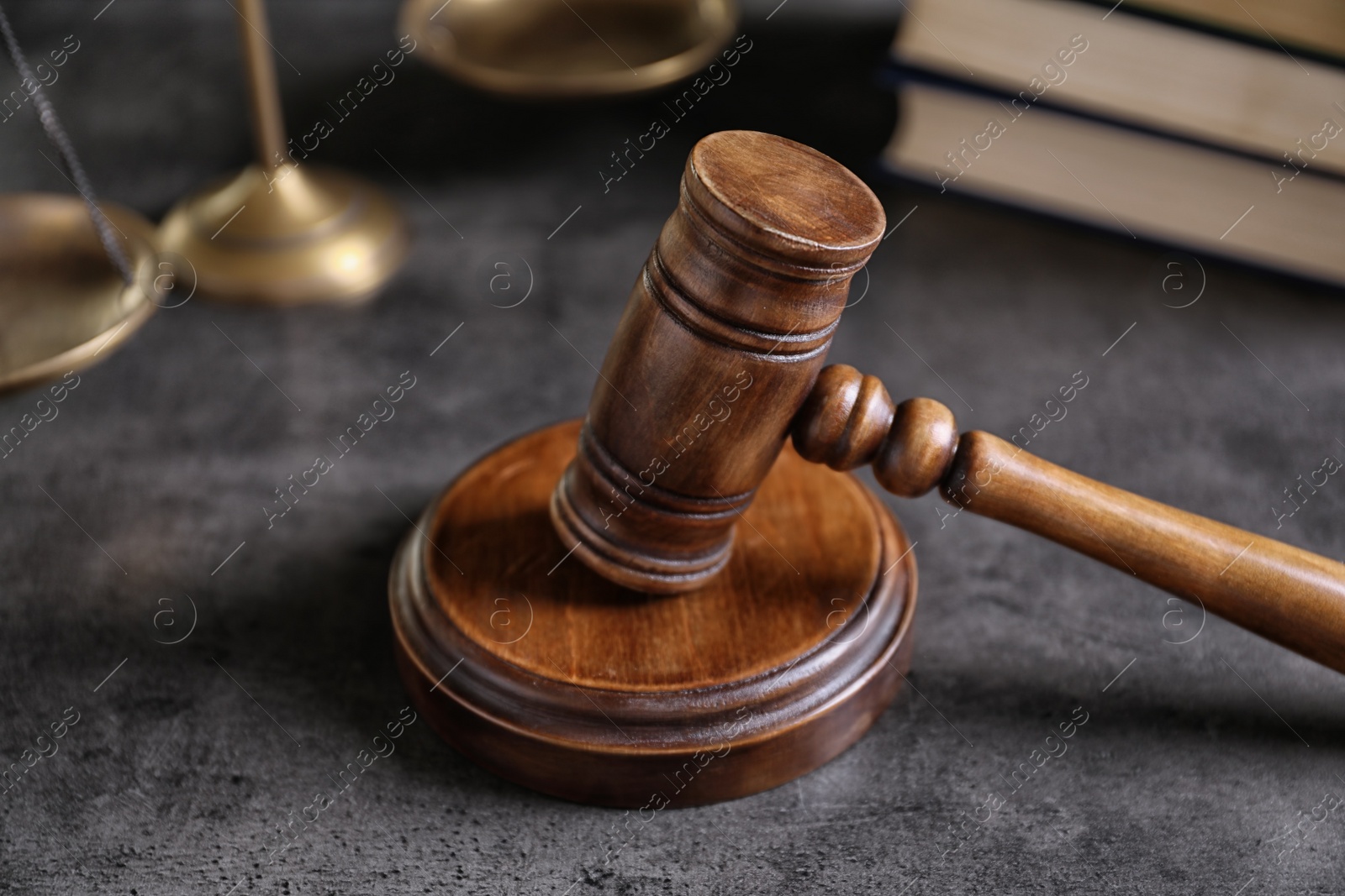 Photo of Judge's gavel and blurred scales on background. Law concept