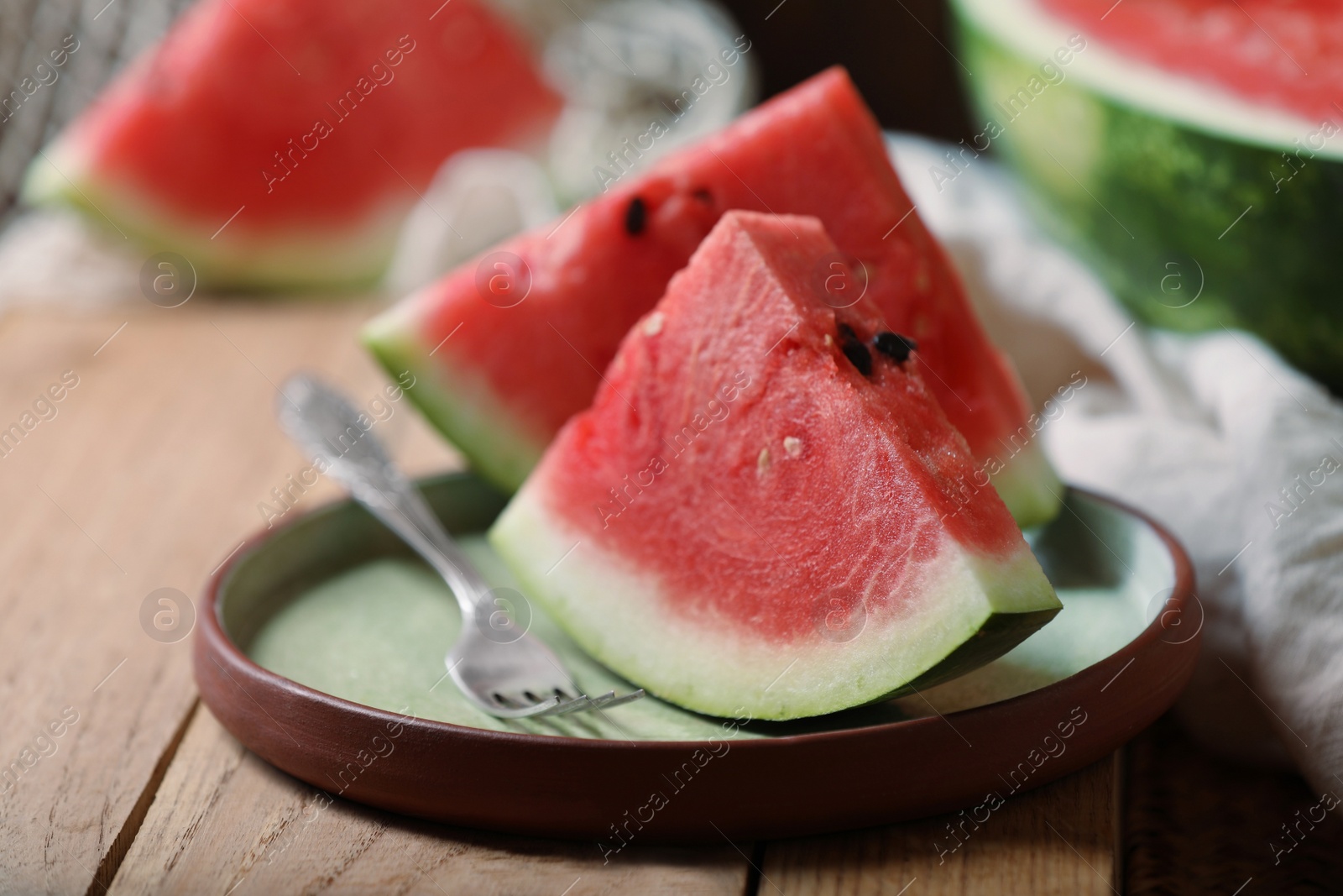 Photo of Sliced fresh juicy watermelon on wooden table, closeup