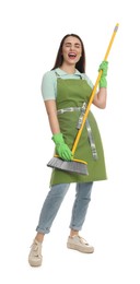Photo of Beautiful young woman with broom singing on white background