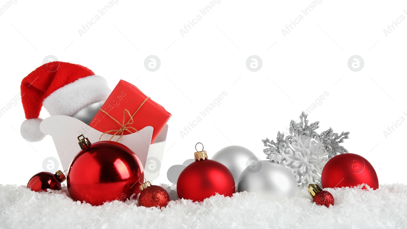 Photo of Christmas tree decoration on artificial snow against white background