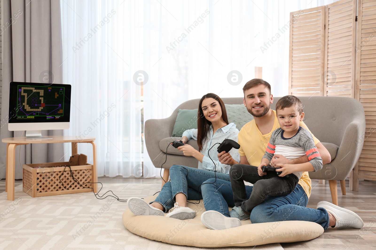 Photo of Happy family playing video games at home. Space for text