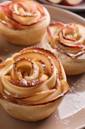 Photo of Freshly baked apple roses on plate, closeup. Beautiful dessert