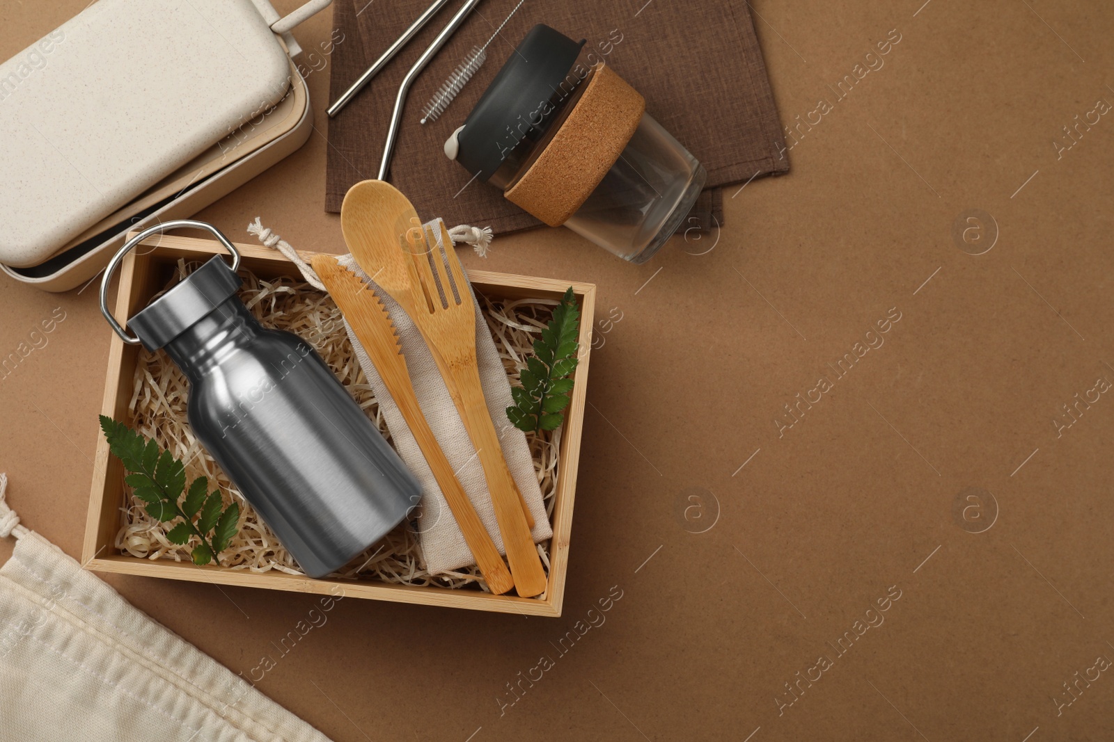 Photo of Flat lay composition with eco friendly products on brown background, space for text