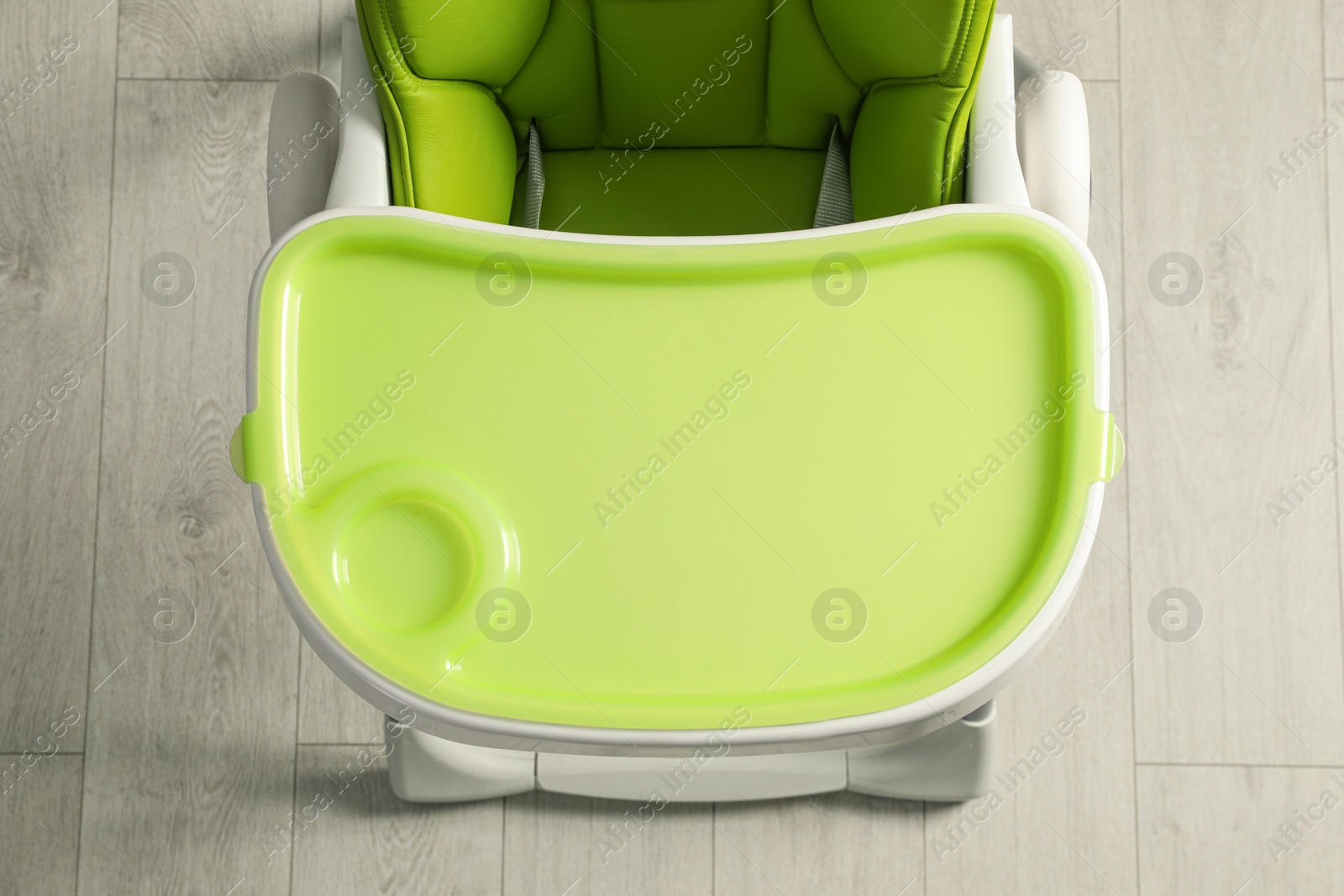 Photo of Green baby high chair indoors, top view